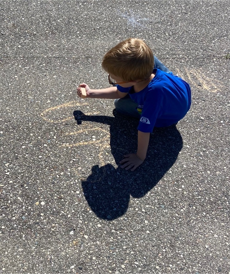 boy writing on playground 