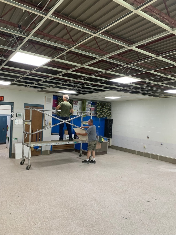 maintenance crew removing ceiling tiles  