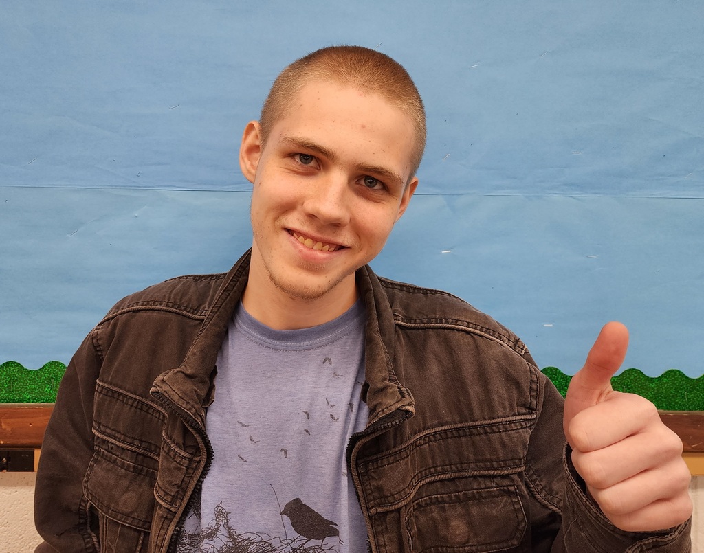 A student giving the thumbs up sign.