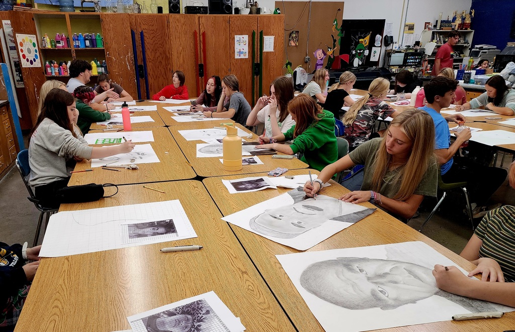 students at tables in an art class